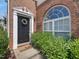 Inviting entryway featuring a decorative wreath, black door, and arched window for natural light at 2021 Rivergate Rd # 102, Raleigh, NC 27614