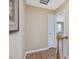 Hallway featuring wood floor and a doorway leading to a bedroom at 2021 Rivergate Rd # 102, Raleigh, NC 27614