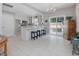 Spacious kitchen with white cabinets, breakfast bar, and sliding door access to the backyard at 2021 Rivergate Rd # 102, Raleigh, NC 27614