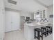 Charming kitchen with breakfast bar, white cabinetry, tile backsplash, and modern appliances at 2021 Rivergate Rd # 102, Raleigh, NC 27614