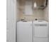 Efficient laundry area featuring front-load washer and dryer with storage shelving at 2021 Rivergate Rd # 102, Raleigh, NC 27614