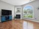 Inviting living room with hardwood floors, fireplace, and large window, creating a bright and welcoming atmosphere at 2021 Rivergate Rd # 102, Raleigh, NC 27614