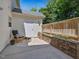 Relaxing patio features concrete flooring, seating area, wood fence, and landscaped brick planter at 2021 Rivergate Rd # 102, Raleigh, NC 27614