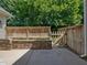Private patio area with a wooden fence and flower bed at 2021 Rivergate Rd # 102, Raleigh, NC 27614