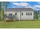 A spacious backyard with a deck and stairs leads to the house, showcasing the rear exterior at 205 Shawnee Dr, Louisburg, NC 27549
