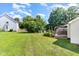 Expansive backyard boasts a well-maintained lawn, storage shed, and deck with pergola at 2108 Carthage Cir, Raleigh, NC 27604