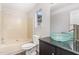 Bathroom with shower-tub combo and black vanity with glass bowl sink at 2108 Carthage Cir, Raleigh, NC 27604