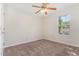 Empty carpeted bedroom with ceiling fan and window at 2108 Carthage Cir, Raleigh, NC 27604