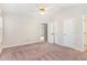 Spacious carpeted bedroom with ceiling fan and double door closets at 2108 Carthage Cir, Raleigh, NC 27604