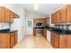 Well-lit kitchen features wood cabinets, black countertops, and stainless steel appliances at 2108 Carthage Cir, Raleigh, NC 27604