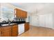 Kitchen featuring wood cabinets, stainless steel sink, and dining area at 2108 Carthage Cir, Raleigh, NC 27604