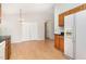 Open kitchen and dining area with wood cabinets and appliances at 2108 Carthage Cir, Raleigh, NC 27604