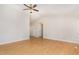 Open living room featuring vaulted ceiling, ceiling fan, and light wood floors at 2108 Carthage Cir, Raleigh, NC 27604