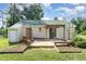 Rear view of home with a deck under a pergola, easy access to garden beds, and a door to the outside at 2108 Carthage Cir, Raleigh, NC 27604
