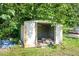 A metal storage shed surrounded by greenery provides ample outdoor storage space at 2108 Carthage Cir, Raleigh, NC 27604