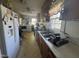 Functional kitchen features stainless steel sink, laminate countertops, and essential appliances at 212 S Sixth St, Smithfield, NC 27577