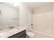Bright bathroom showcasing a tub/shower combo with white tile surround and a vanity with granite countertop at 213 Clement Ave, Oxford, NC 27565