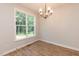 Bright dining room with hardwood floors, large window, and modern chandelier at 213 Clement Ave, Oxford, NC 27565