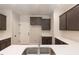 Spacious kitchen featuring gray cabinets, white countertops, stainless steel sink, and a pantry at 213 Clement Ave, Oxford, NC 27565