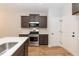 Modern kitchen with gray cabinets, stainless steel appliances, and white countertops at 213 Clement Ave, Oxford, NC 27565