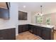Stylish kitchen showcasing gray cabinets, stainless steel appliances, and a central island with a sink at 213 Clement Ave, Oxford, NC 27565