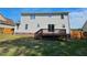 Backyard view with a wooden deck, lush green grass, and privacy fence at 216 Edgecombe Dr, Spring Lake, NC 28390