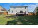 Backyard view with a wooden deck, lush green grass, and privacy fence at 216 Edgecombe Dr, Spring Lake, NC 28390