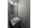 Bathroom vanity featuring a single sink, contemporary faucet, framed mirror, and modern lighting at 216 Edgecombe Dr, Spring Lake, NC 28390
