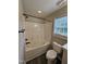 Bathroom featuring a shower-tub and toilet at 216 Edgecombe Dr, Spring Lake, NC 28390