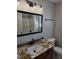 Bathroom featuring granite counters, black fixtures, shower and vanity at 216 Edgecombe Dr, Spring Lake, NC 28390