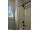 Bathroom shower featuring black fixtures and natural lighting from the window at 216 Edgecombe Dr, Spring Lake, NC 28390