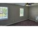 Carpeted bedroom featuring natural lighting from the two windows at 216 Edgecombe Dr, Spring Lake, NC 28390