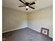 Neutral bedroom featuring a ceiling fan, plush carpet, and a small framed picture on the floor at 216 Edgecombe Dr, Spring Lake, NC 28390