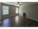 Spacious bedroom with a ceiling fan, two large windows, and modern flooring at 216 Edgecombe Dr, Spring Lake, NC 28390