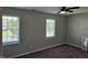 Carpeted bedroom featuring natural lighting from the two windows at 216 Edgecombe Dr, Spring Lake, NC 28390