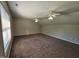 Carpeted bedroom featuring two ceiling fans and large windows with natural light at 216 Edgecombe Dr, Spring Lake, NC 28390
