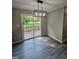 Charming dining area with modern light fixture and sliding glass doors to the back deck at 216 Edgecombe Dr, Spring Lake, NC 28390