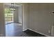 Bright dining room featuring gray-toned wood floors and modern light fixture, with deck view at 216 Edgecombe Dr, Spring Lake, NC 28390