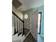 Inviting entryway showcasing staircase with black banister, an octagon window, and a front door at 216 Edgecombe Dr, Spring Lake, NC 28390