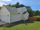 Exterior view of home showing neutral siding, brick foundation and side-entry garage at 216 Edgecombe Dr, Spring Lake, NC 28390