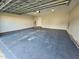 Spacious garage with painted floor, water heater, and access door at 216 Edgecombe Dr, Spring Lake, NC 28390
