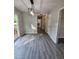Bright hallway with hardwood floors leading past a half bathroom to the main entrance at 216 Edgecombe Dr, Spring Lake, NC 28390