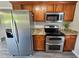 Updated kitchen featuring stainless steel appliances, granite countertops, and wood cabinetry at 216 Edgecombe Dr, Spring Lake, NC 28390