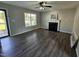 Bright living room featuring a fireplace, ceiling fan, and gray-toned wood floors at 216 Edgecombe Dr, Spring Lake, NC 28390