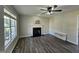 Bright living room featuring a fireplace, ceiling fan, and gray-toned wood floors at 216 Edgecombe Dr, Spring Lake, NC 28390