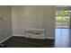Bright living room with gray-toned wood floors featuring artwork and a glimpse of the deck at 216 Edgecombe Dr, Spring Lake, NC 28390