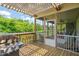 Outdoor grill on a wooden deck and partially screened-in patio perfect for summer barbecues and relaxation at 216 Tarkenton Ct, Clayton, NC 27527