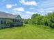 Beautiful backyard with a screened porch and lush green lawn at 216 Tarkenton Ct, Clayton, NC 27527