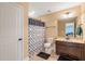 Cozy bathroom with a vanity, toilet, and shower with a patterned curtain for added style at 216 Tarkenton Ct, Clayton, NC 27527