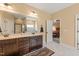Spacious primary bathroom featuring double sinks, dark wood cabinets and separate shower and tub at 216 Tarkenton Ct, Clayton, NC 27527